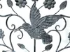 A close-up of a metal garden decoration featuring a hummingbird and flowers. Podgląd zdjęcia produktu