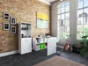 A home office with a white desk, shelving unit, and artwork on a brick wall, with large windows overlooking a city. Produktbild-Vorschau