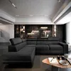 A modern living room with a dark sectional sofa against a textured stone wall. Podgląd zdjęcia produktu