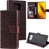 A collage of images showing a brown leather flip phone case with a mandala pattern, a phone inside the case, and the case's interior card slots. Produktbild-Vorschau