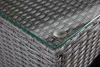 Close-up of the corner of a grey rattan outdoor furniture set with a glass top. Produktbild-Vorschau