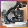 A pair of black push-up bars on a white pedestal against a blurred background. Podgląd zdjęcia produktu