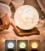 A person's hand is touching a levitating moon lamp, with three color options displayed below. Produktbild-Vorschau