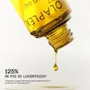 A close-up of Olaplex No. 7 Bonding Oil being dispensed from the bottle, with marketing text overlay. Voir les images du produit