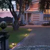 A grand house with outdoor lighting at dusk. Produktbild-Vorschau