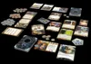 A collection of board game components, including cards, tokens, and a deck box, arranged on a black surface. Anteprima dell’immagine prodotto