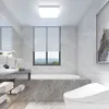A modern bathroom with a bathtub, toilet, and vanity. Anteprima dell’immagine prodotto