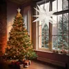 A decorated Christmas tree with gifts underneath, next to a window with a snowy outdoor scene and a hanging star decoration. Podgląd zdjęcia produktu
