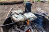 Food wrapped in foil is being cooked over a campfire, with a coffee pot in the background. Anteprima dell’immagine prodotto