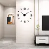 A modern living room with a large wall clock, a painting, and a TV stand. Produktbild-Vorschau