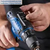 A person's hands are adjusting a switch on a cordless drill. Produktbild-Vorschau