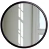A round mirror with a black frame is shown against a white wall with light reflections. Anteprima dell’immagine prodotto