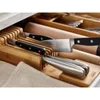 A close-up view of knives stored in a bamboo drawer organizer. Náhled obrázku produktu