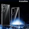 Two clear phone cases are displayed against a dark, starry background with blue light effects. Produktbild-Vorschau