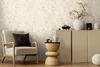 A cozy living room corner with a chair, side table, and cabinet. Produktbild-Vorschau