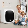 A mother and daughter are sitting on the floor next to a mini clothes dryer. Náhľad obrázku produktu