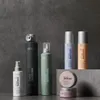 A collection of Revlon Style Masters hair products arranged on a textured gray background and a gray stone surface. Produktbild-Vorschau