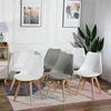 A set of dining chairs in a room setting. Voir les images du produit