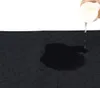 Water being poured onto a black training pad. Náhľad obrázku produktu