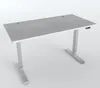 A modern, height-adjustable desk with a stone-gray surface and silver metal legs, presented against a plain light gray background. Anteprima dell’immagine prodotto