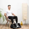 A man is sitting in a chair using a foot massager. Náhľad obrázku produktu