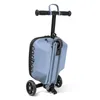 A light blue three-wheeled scooter with a handle and a small suitcase attached. Produktbild-Vorschau