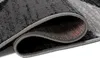 A close-up view of a rolled-up rug, showing the texture and edge binding. Voir les images du produit