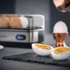 A breakfast set with an egg cooker and boiled eggs. Voir les images du produit