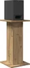 A black speaker sits on top of a wooden stand. Náhľad obrázku produktu