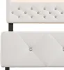 A close-up view of a white upholstered bed frame, showing the tufted headboard and the diamond-patterned side panel. Produktbild-Vorschau