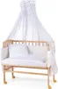 A baby bedside crib with a canopy and bedding. Produktbild-Vorschau