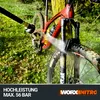 A red mountain bike is being cleaned with a pressure washer in an outdoor, grassy setting. Produktbild-Vorschau