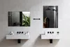 A modern bathroom with two sinks and mirrors. One mirror reflects a bathroom interior with plants, and the other shows a woman showering. Produktbild-Vorschau