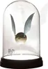 A Harry Potter Golden Snitch displayed under a glass dome on a black base. Podgląd zdjęcia produktu