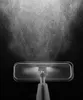 A close-up, black and white shot of a mop head spraying water. Podgląd zdjęcia produktu
