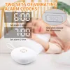 A person sleeping in bed with a vibrating alarm clock next to them, with text overlays highlighting features. Podgląd zdjęcia produktu