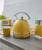A kitchen counter with a yellow kettle, mug, and radio. Náhled obrázku produktu