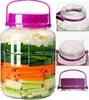 A collage of images showing a large plastic jar filled with layered vegetables, and close-ups of its lid and handle. Produktbild-Vorschau