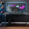A gaming setup with a desk, computer, monitor, and accessories, illuminated by LED lights. Produktbild-Vorschau