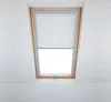 A skylight window with a white roller blind. Produktbild-Vorschau