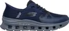 A side view of a navy blue Skechers shoe with a gray sole. Voir les images du produit