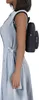 A person wearing a blue dress and a black backpack, shown from the side. Produktbild-Vorschau