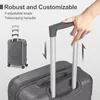 A hand is shown adjusting the telescoping handle of a gray suitcase, with a smaller suitcase shown in the background. Produktbild-Vorschau