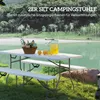 A picnic table and benches set up outdoors by a lake. Produktbild-Vorschau