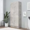 A tall, gray wardrobe with two doors stands against a light gray wall, next to a large potted plant and a window with sheer curtains. Náhled obrázku produktu