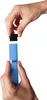 Hands assembling a blue tube-like product with a black cap. Anteprima dell’immagine prodotto