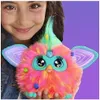 A girl is holding a colorful Furby toy. Náhľad obrázku produktu