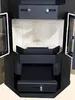 A front view of a black corner fireplace with its doors open. Anteprima dell’immagine prodotto