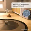 A robot vacuum cleaner is shown on a wooden floor, with a graphic indicating it avoids pet waste. A basket and furniture are in the background. Náhled obrázku produktu