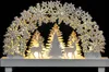 A decorative Christmas arch with snowflakes, trees, and reindeer, illuminated by warm lights. Podgląd zdjęcia produktu